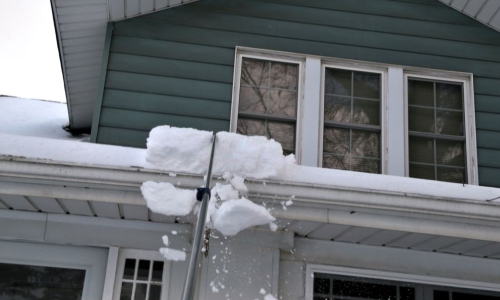 Ice dams on roof gutter